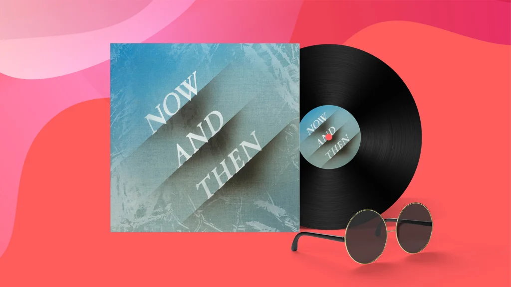 A record cover with the text ‘Now And Then’ with its record darting out from its sleeve, sitting next to a pair of sunglasses against a pink background.