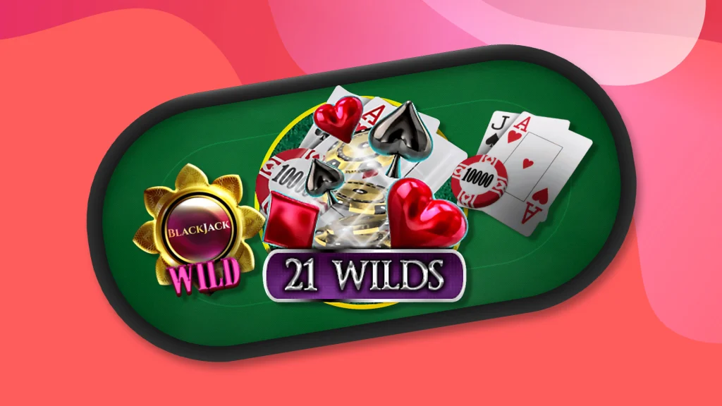 An oval blackjack table with green felt has playing cards and slot symbols on top with the text ‘21 Wilds’, all on a pink background.